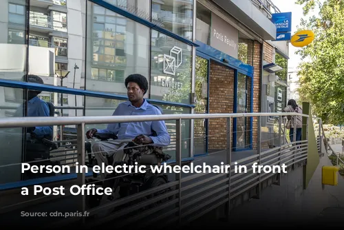 Person in electric wheelchair in front of a Post Office