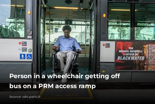  Person in a wheelchair getting off a bus on a PRM access ramp